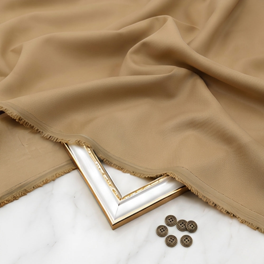 Beige fabric with a gold frame and buttons on a white surface