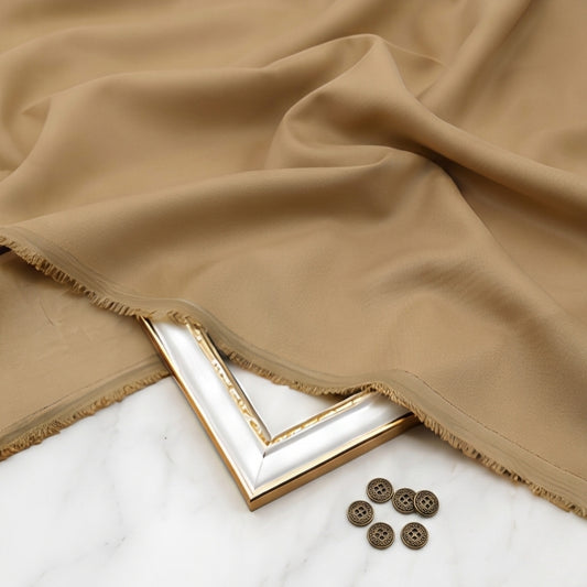 Beige fabric with a gold frame and buttons on a white surface